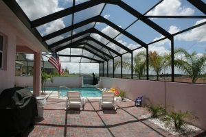 A vaulted swimming pool enclosure on a cloudy day.