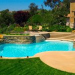 A freeform pool in a beautifully landscaped backyard.