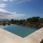 Geometric vanishing edge pool overlooking lush landscape in San Diego.