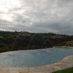 Pool with vanishing edge overlooking landscape.